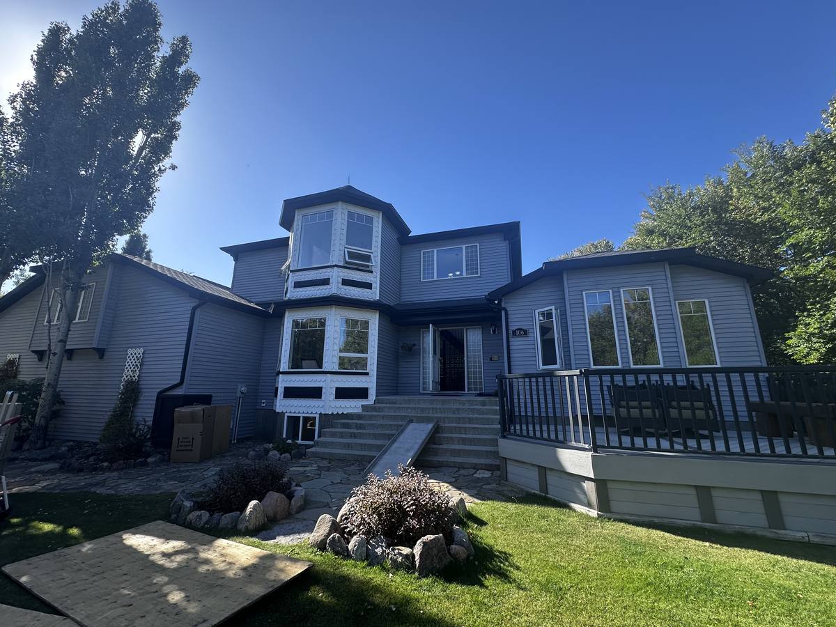 Lethbridge County home on moving day with a ramp laid over the front steps and plywood runners across the lawn, Western Provincial Movers job