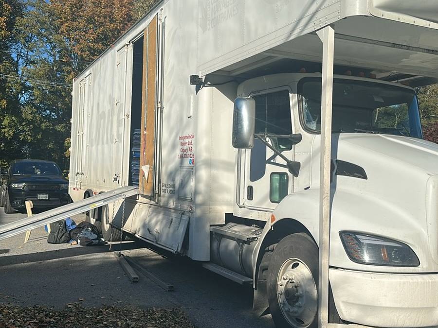 Western Provincial Movers truck with the side door open and the ramp out on a fall moving day